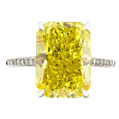 Fancy vivid yellow 5.04 carat rectangular radiant cut diamond engagement ring. Mounted in 2.7g of Platinum with a delicate thin half diamond pave encrusted band. GIA Certified. Certificate No. 6183449015. Size 6.5. Resizing available upon request. Viewings available in our NYC showroom by appointment. Yellow Engagement Ring, Radiant Engagement Ring, Radiant Cut Diamond Engagement Rings, Radiant Cut Diamond Ring, Radiant Engagement, Yellow Diamond Earring, Citrine Ring Engagement, Yellow Diamond Ring, Radiant Cut Engagement Rings