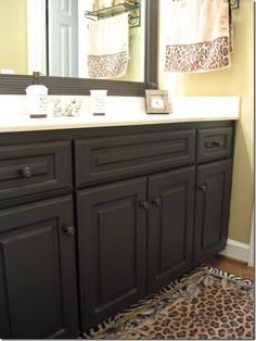 a bathroom vanity with leopard print rug on the floor