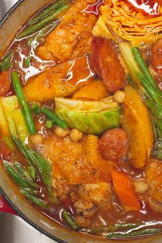 a pot filled with meat and vegetables on top of a stove