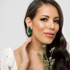 Show off your other worldly sense of style with these Green Gold Small Wing Earrings. Made to look like an angel wing, the statement earrings are adorned with opulent green and gold-toned sequins layered atop one another to form the wings. They are sure to make a chic fashion statement at any party or outing. Size: Length: 2''/ Width: 1'' Glamorous Green Earrings, Glamorous Green Crystal Earrings For Party, Glamorous Green Crystal Earrings, Wing-shaped Earrings For Party, Green Crystal Drop Earrings For Evening, Gold Wing-shaped Earrings For Party, Gold Wing-shaped Party Earrings, Small Wing, Prom Earrings