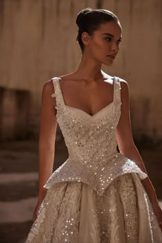 a woman in a wedding dress with sequins on the boudon and straps