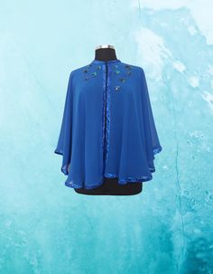 Feel like royalty in this stunning Royal blue chiffon evening cape/shawl.  This one-of-a-kind piece is hand embellished with artsy details, perfect for making a statement at any event. Each circle is meticulously hand embroidered with sequins and appliqued onto the cape with care.  The glitter ribbon frame trim adds an extra touch of elegance and sophistication to this beautiful evening cover up.  This L-XL cape is truly a work of art that will make you stand out in style. One of a kind  Fastened with a hook and loop at the front, Bust - will fit up to 44" Center back length approx 22 inches.(55cm) circumference around the neck is18.89inches( 48 cm ) Care: Dry Clean READY TO SHIP *The style I used was originally designed and professionally constructed by me. Each item of my shop has a spec Blue One Size Cape, One Size Blue Cape, Blue One-size Cape, Half Cape, Dress Topper, Formal Top, Cape Shawl, Formal Tops, Glitter Ribbon