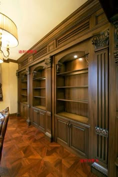 an empty room with wooden furniture and chandelier