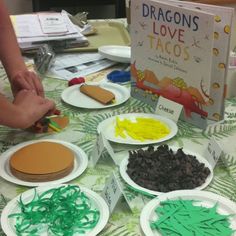 the table is covered with paper plates and craft supplies