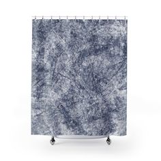 a shower curtain with a blue and white pattern on the outside, in front of a white background