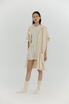 Our signature oversized robe features a short kimono-esque sleeve, ample hood and belted drawstring to be worn loose or synched around the waist. The above knee length and short sleeves gives you the perfect amount of coverage to lounge around in or go about your activities without feeling weighed down. Made in organic cotton imported from Portugal, this double faced knit features a luxurious brushed exterior and a quick absorbing terry loop interior. *Due to the delicacy of this fabric, the tex Oversized Summer Loungewear Outerwear, Casual Oversized Robe For Loungewear, Beige Short Sleeve Summer Outerwear, Short Sleeve Summer Outerwear For Beach, Terry Robe, Hooded Robe, Short Kimono, Above Knee, Persona