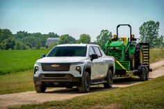 White 2024 Chevrolet Silverado EV WT towing a green tractor. Ford Lightning, Silverado Truck, Electric Pickup, Porsche 718 Cayman, Cayman Gt4, Porsche Motorsport, Work Truck, Twin Turbo