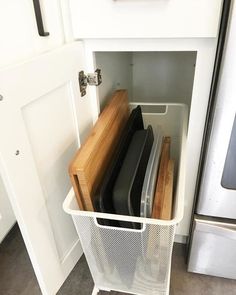 a kitchen cabinet filled with lots of different types of items in it's storage area