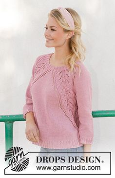 a woman wearing a pink sweater and headband