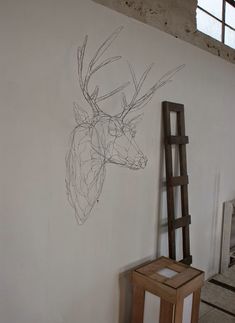 a drawing of a deer on the wall next to a ladder