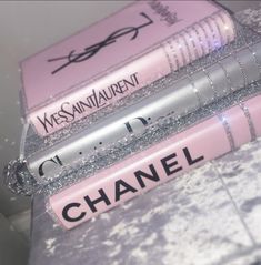 three chanel books are stacked on top of each other