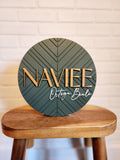 a wooden stool with a sign that says naviee on it