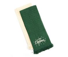 a green and white towel with the words christmas written in white on it's side