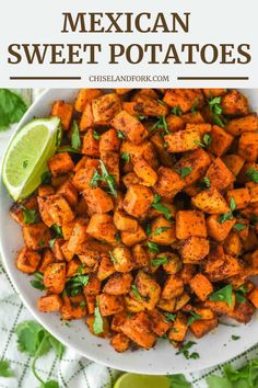 mexican sweet potatoes in a white bowl with cilantro and lime on the side