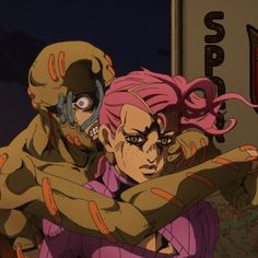 two anime characters hugging each other in front of a sign