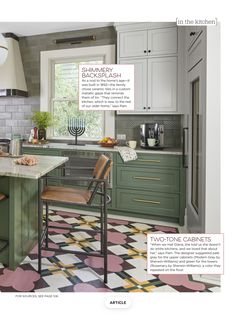 a kitchen with green and white cabinets, patterned flooring and an island in the middle