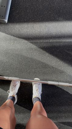 a person standing on a skateboard with their feet propped up against the edge of it