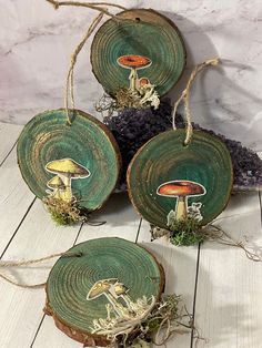 three pieces of wood with mushrooms painted on them