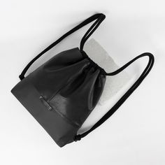 Genuine leather women's/ unisex black backpack / gymbag / drawstring leather bag. 100% recycled leather, made out of a vintage leather garment, and industrial leather waste ♻️ Absolutely unique one-of-a-kind piece.  Comfortable to wear, perfect choice for everyday use. Backpack size: Height: 37 cm (~ 14.5 inches) Width: 35 cm (~ 13.7 inches) Depth: 5,5 cm (~ 2.2 inches) Fully lined with high quality black cotton material.   Two pockets inside.:  14cm x 15cm  /5.5 x 5.9 inches/ Made with patience Black Soft Leather Backpack For Daily Use, Casual Black Drawstring Bag With Large Capacity, Leather Drawstring Bag For Travel, Leather Drawstring Travel Bag, Soft Leather Drawstring Bag For Daily Use, Soft Leather Drawstring Bag For Travel, Black Large Capacity Drawstring Backpack, Soft Leather Drawstring Travel Bag, Daily Use Soft Leather Drawstring Bag