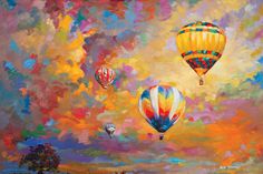 three hot air balloons flying in the sky