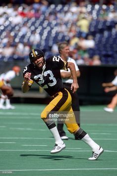 a football player running with the ball in his hand during a game against the oakland rams