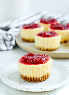 mini cheesecakes with raspberry topping on plates