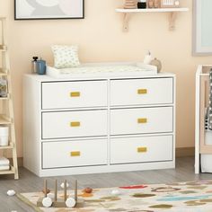 a baby's room with a dresser, crib and toys on the floor