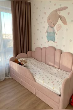 a child's room with a pink bed and wallpaper on the walls is decorated in pastel colors