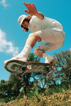 a man in the air on a skateboard doing a trick with his hands and feet