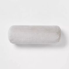 a roll of toilet paper sitting on top of a white wall