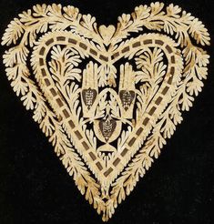 an intricately designed heart on black velvet