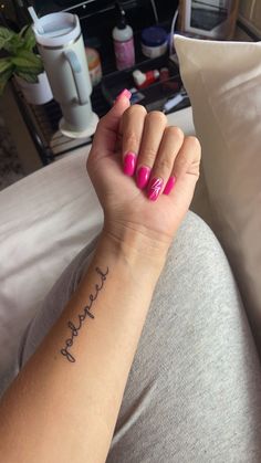 a woman's arm with a small tattoo on it that reads, happy mother