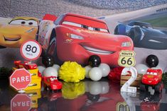 cars birthday party decorations including balloons, cake toppers and race car figurines