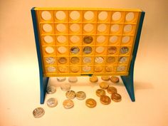 a plastic tray with coins in it on a white table next to a blue and yellow stand