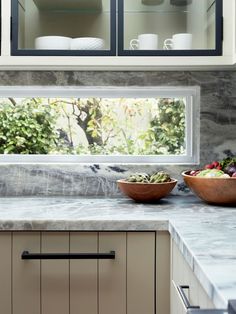 two bowls of food are sitting on the kitchen counter