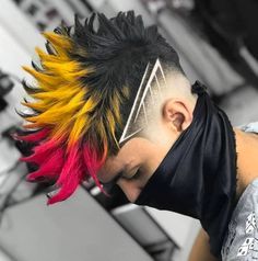 a young man with colorful hair wearing a black face mask