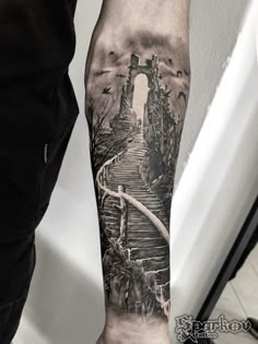 a man with a black and white tattoo on his arm that has stairs going up it