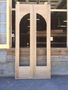 two wooden doors sitting in front of a building