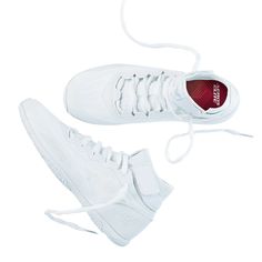 a pair of white tennis shoes on a white background