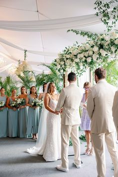 the bride and groom are getting married in front of their guests at this wedding ceremony