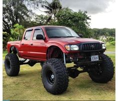 a red pick up truck parked in the grass