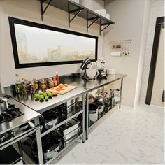 a kitchen with stainless steel counter tops and appliances