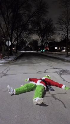 a stuffed animal laying on the ground in the middle of the street at night time