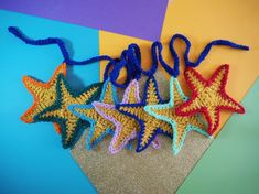 three crocheted starfishs on a colorful background