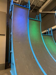 a skateboard ramp with blue and green lights on it