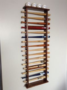 a rack with baseball bats hanging on the wall