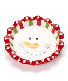 a red and white plate with a smiling snowman on it's face in front of a white background