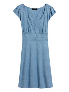 Cute dress.  This mini has it all: a row of delicate, covered buttons, feminine flutter sleeves, and a gently A-line skirt.  Plus, it's made with a summer-ready, stretch-cotton chambray.  Low v-neck.  Invisible zip at side.  Elastic smocking at back waist.  Unlined.  Produced in a facility that runs P. A. C. E.  – Gap Inc. 's program to educate and empower women in the communities where our products are made.  Learn more HERE Fit & Flare: Fitted through the chest and waist, flare skirt.  Sho Banana Republic Style, Stripped Dress, Button Front Dress, Chambray Dress, Fantasy Dress, Banana Republic Dress, Cute Dress, Petite Dresses, Flutter Sleeves