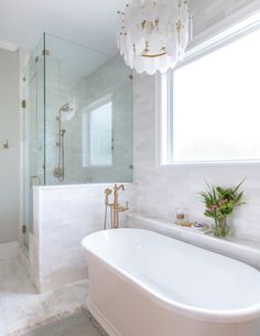 a white bath tub sitting next to a window