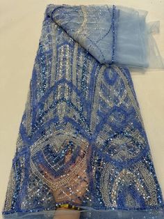 This high quality Fabric is measured in 5 Yards With Embroidered Beading and Sequin. It is soft, very delicate and beautiful. This high Quality Fabric is made with Fashion embroidered rhinestones can be used in making party wedding dresses, skirts, shawls, scarves and other other fashion apparels as you would like. Size : Length : 5 yards (180 inch). Width: 50 inch (Please allow slight deviation for the measurement data ,±1 inch) Material: 100% Polyester, Tulle Lace Fabric, Eco-Friendly embroide Blue Embroidered Wedding Fabric With Rhinestones, Elegant Embroidered Blue Sequin Fabric, Elegant Blue Embroidered Sequin Fabric, Elegant Blue Embellished Sequin Fabric, Beaded Organza Embroidered Fabric For Party, Elegant Blue Embellished Embroidered Fabric, Blue Embellished Embroidered Fabric For Wedding, Elegant Blue Beaded Sequin Fabric, Elegant Rhinestone Embroidered Fabric For Banquet